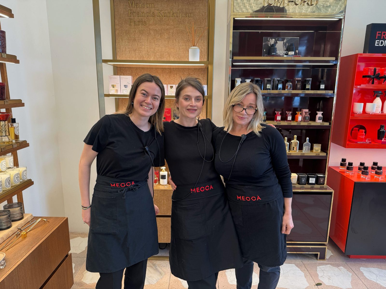 Ella with the team on the floor at MECCA, in front of the fragrance displays